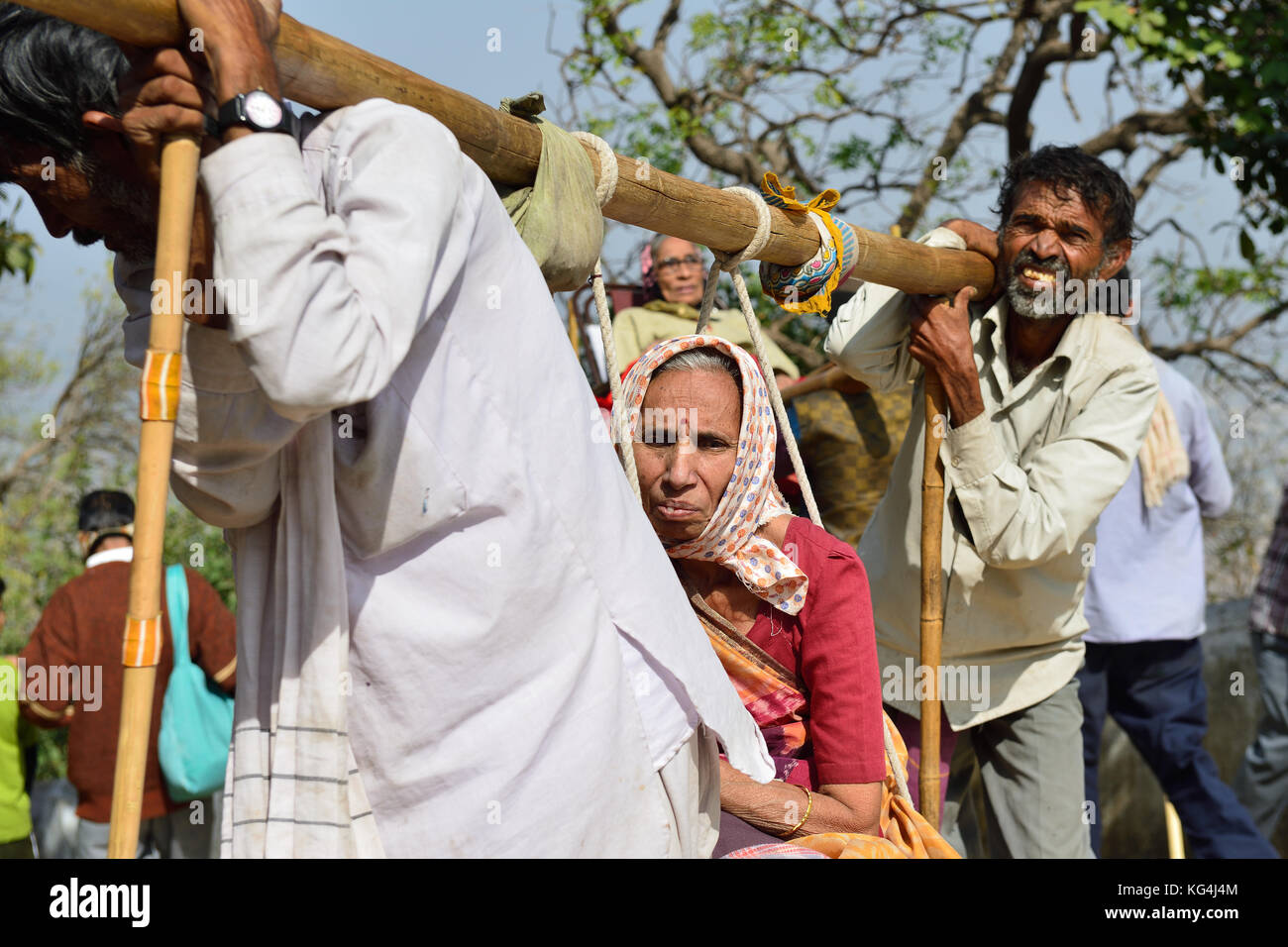 PALITANA, GUJARAT, INDIA - JANUARY 25: Indian pilgrims carried on primitive sedan chairs to the holy Palitana top in the Gujarat state in India, Palit Stock Photo