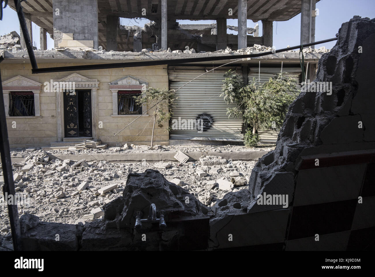 Raqqa, Syria. 12th Aug, 2017. A shop door featuring the logo of ISIS. In Summer 2017 the Syrian Democratic Forces (SDF) launched a battle against ISIS in Raqqa in order to regain control of the city from the terrorist organization. The operation led to at least 3000 deaths including fighters from both sides and civilians. Credit: Jake Simkin/SOPA/ZUMA Wire/Alamy Live News Stock Photo