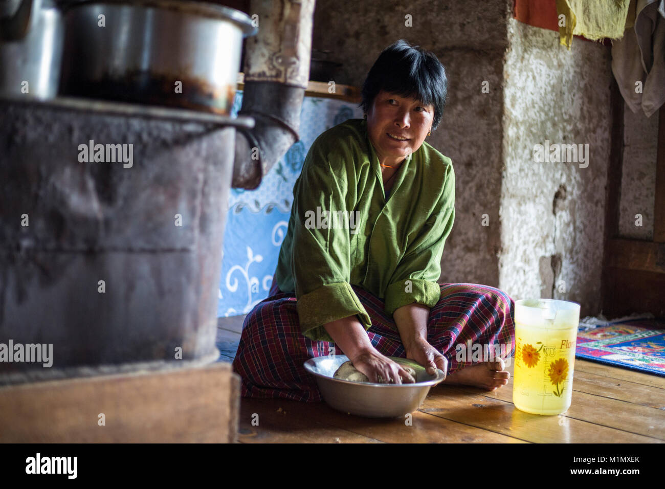 Bumthang, Bhutan.  Mixing Water with  Buckwheat Flour to Make Noodles. Stock Photo