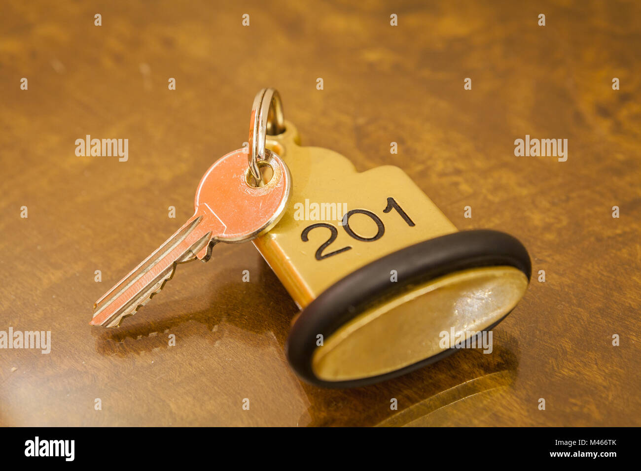 Hotel Room Key lying on Bed with keyring Stock Photo