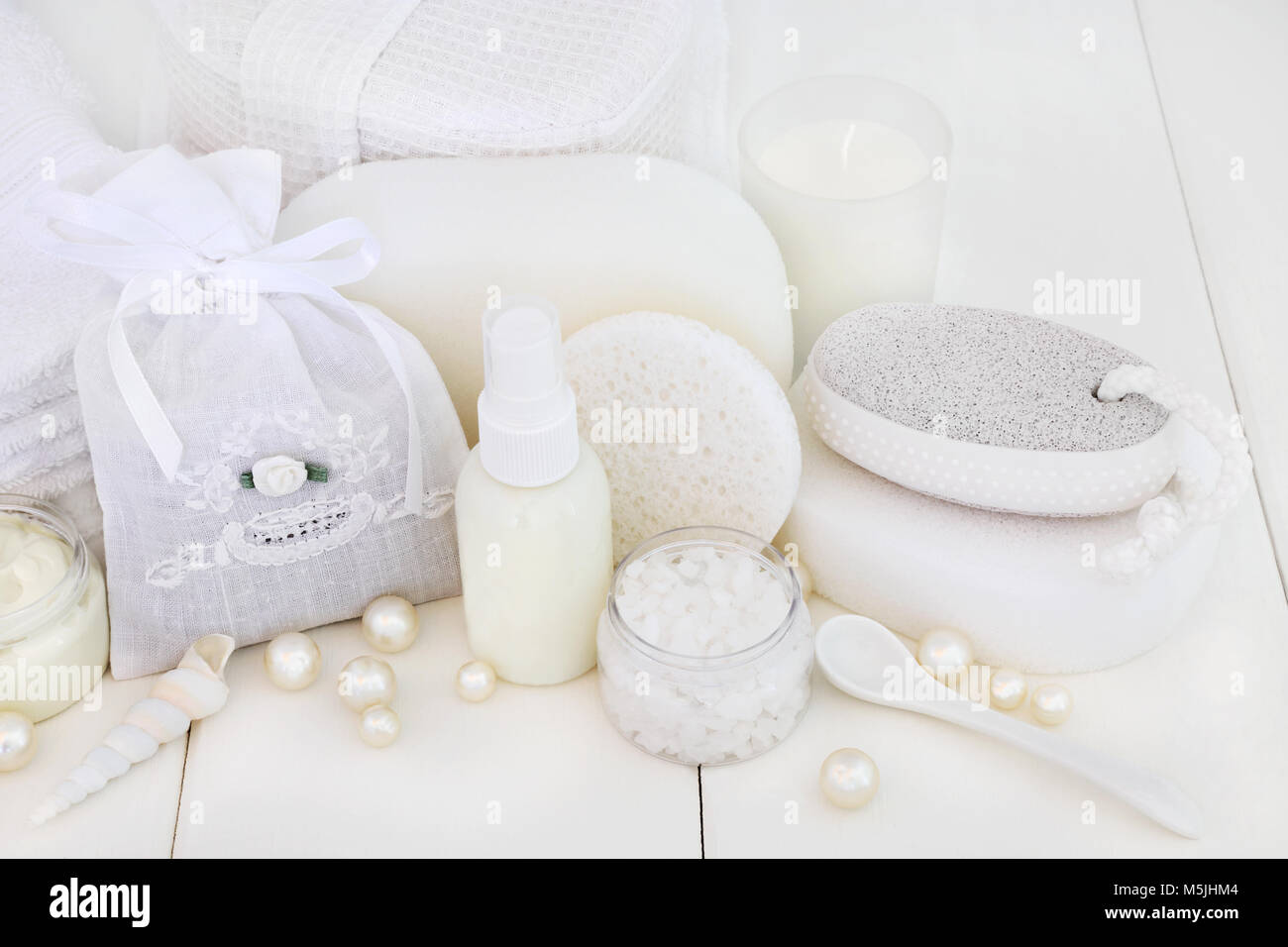 Ex foliation beauty treatment products with salt, pumice body scrub, moisturising cream, body lotion, sponges, wash cloths and decorative pearls. Stock Photo