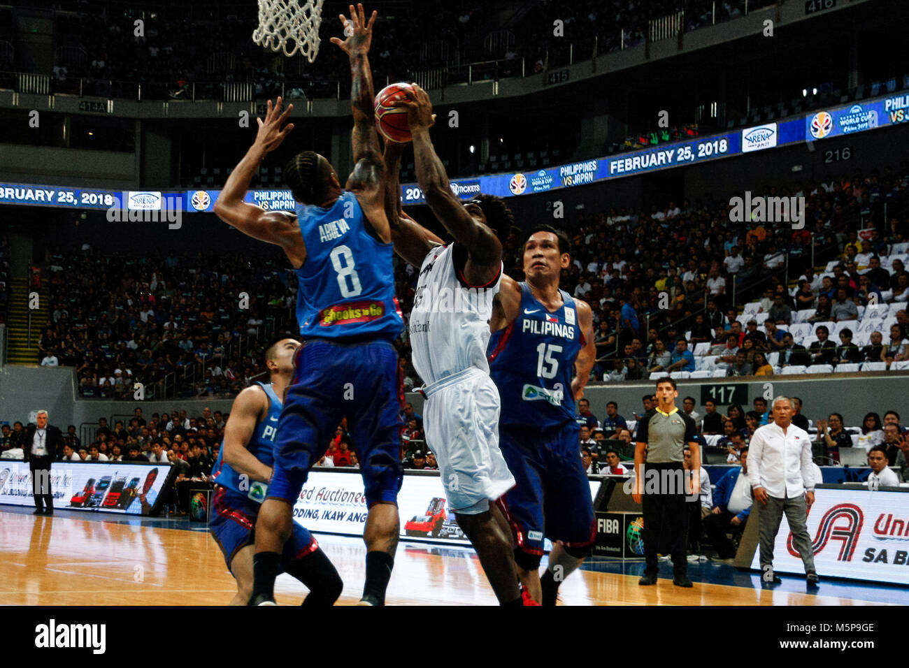 Philippines. 25th Feb, 2018. Ira Brown (35) of team Japan tries to score a basket against Calvin Abueva (8) during the qualifying game at the MOA Arena. The Philippine and Japanese basketball team met at the hardcourt of the Mall of Asia Arena in Pasay City, for the FIBA World Cup 2019 Asian Qualifiers. The Philippines won over Japan, 89-84. Credit: J Gerard Seguia/ZUMA Wire/Alamy Live News Stock Photo