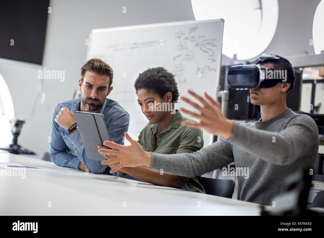 Team working on virtual reality headset Stock Photo