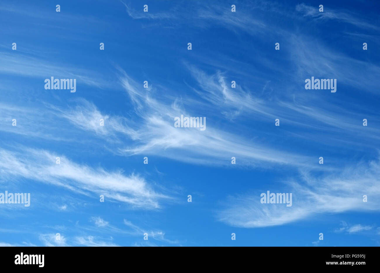 'Mares' tails and mackerel scales make lofty ships to carry low sails.' Cirrus Unicus clouds indicate strong winds to come. Mares' tails Stock Photo