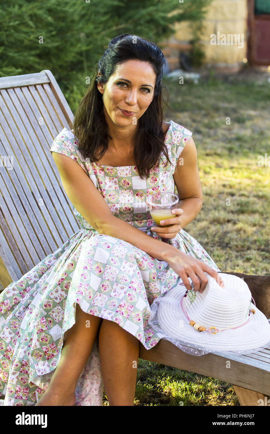 Woman gardening. Mature girl gardening in her backyard. spring season, rural scene Stock Photo