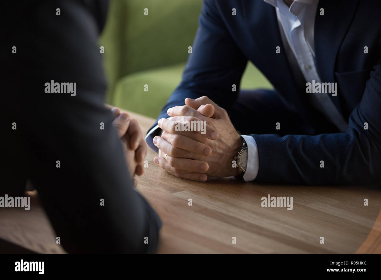 Confident businessmen sitting opposite of each other at business Stock Photo