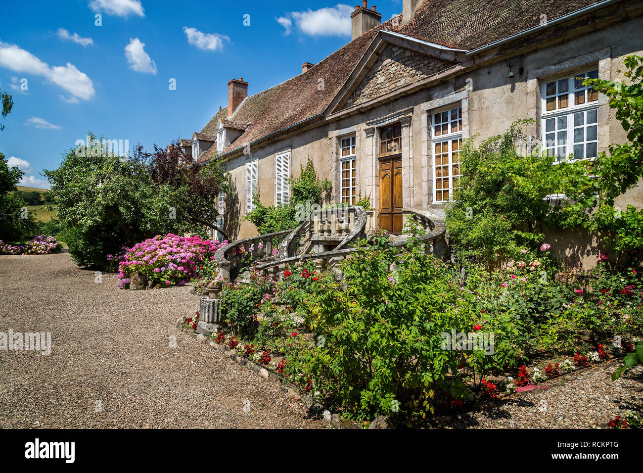 Medieval French Mansion with sweeping circular steps to front door in Autun, Burgundy, France on 25 June 2014 Stock Photo