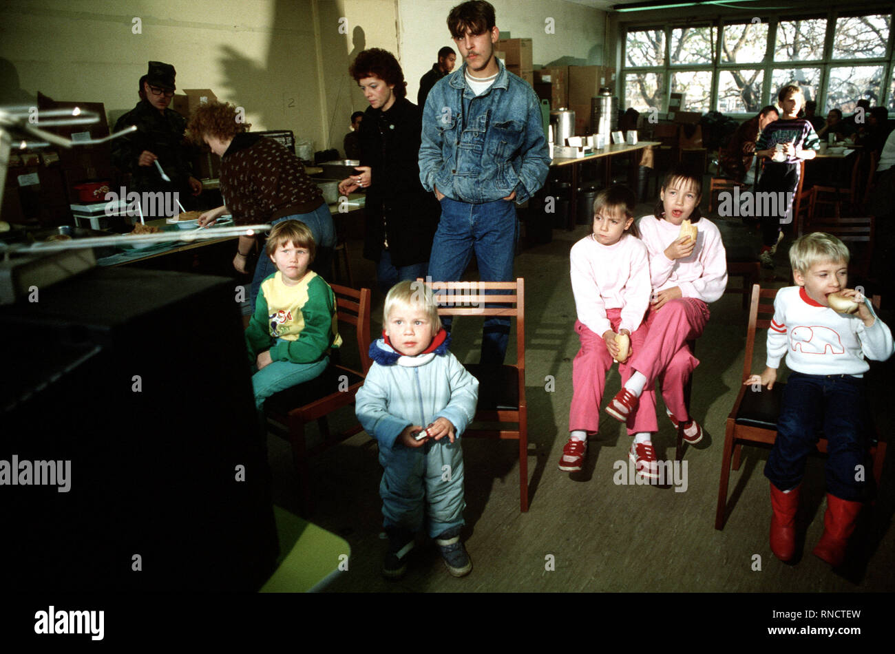 East German children enjoy a snack at the refugee center in West Berlin. Stock Photo