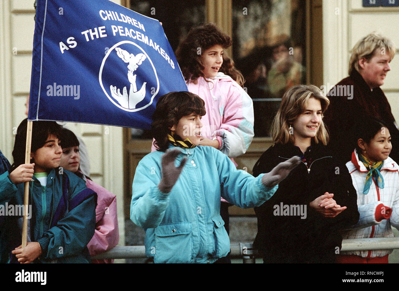 West German children display a banner as they welcome East German visitors driving through Checkpoint Charlie.  The East Germans are taking advantage of relaxed travel restrictions to visit the West. Stock Photo