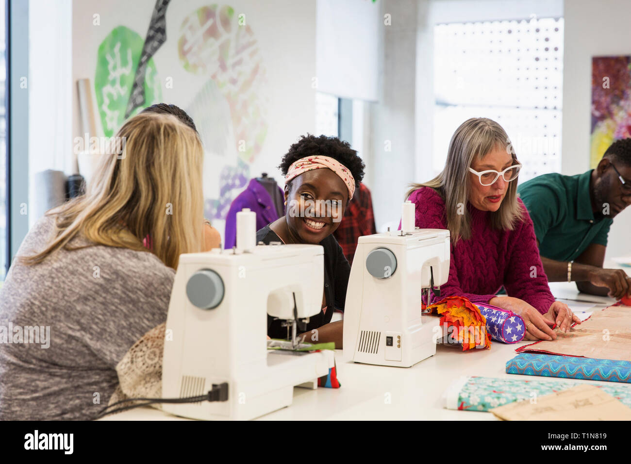 Female fashion designers working at sewing machines in studio Stock Photo