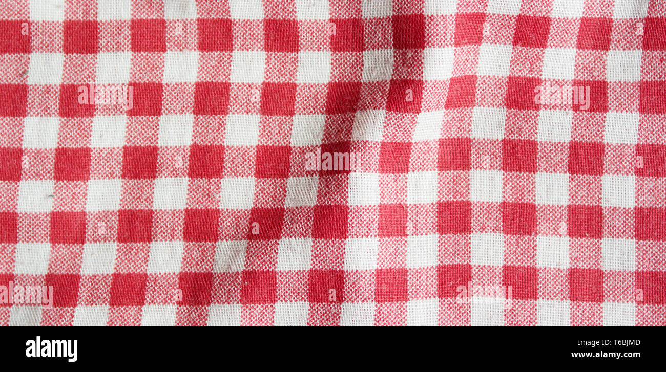 Red linen picnic tablecloth. Texture of checkered picnic blanket. Stock Photo