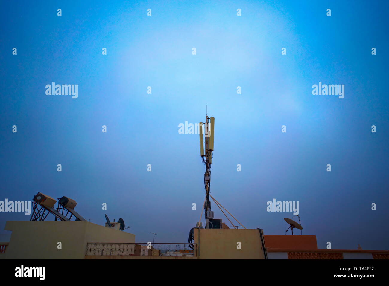 mobile telecommunications antenna on a roof Stock Photo