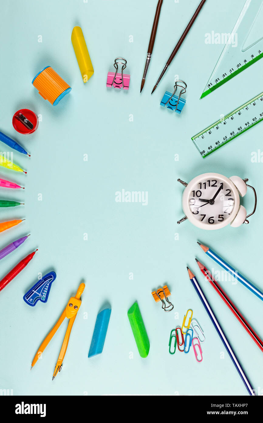 Concept back to school. Written and school supplies on blue pastel background. Education, learning concept. Creative writing and stationery. Copy spac Stock Photo