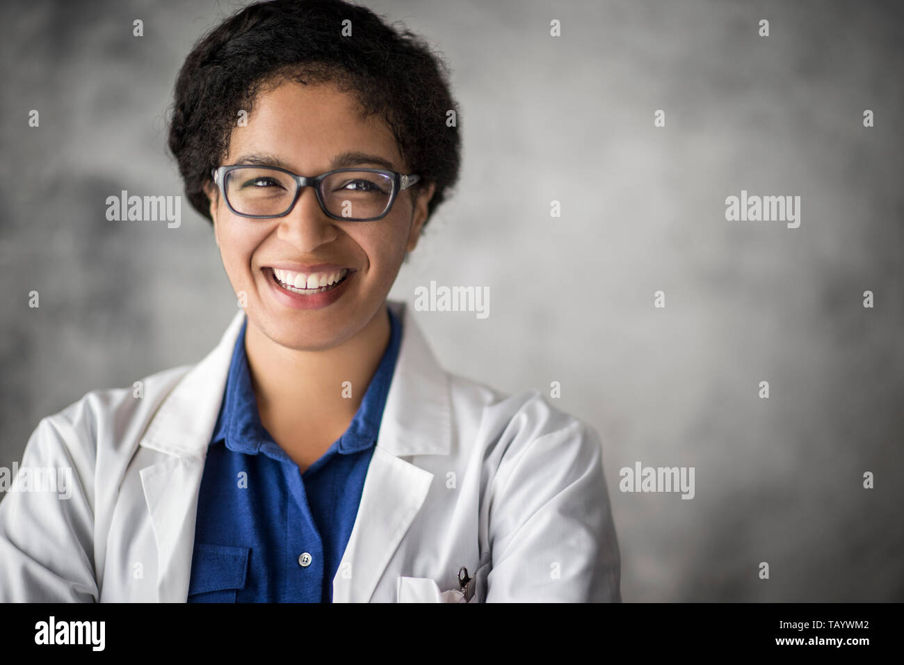 Scientist examining a sample through a microscope. Stock Photo