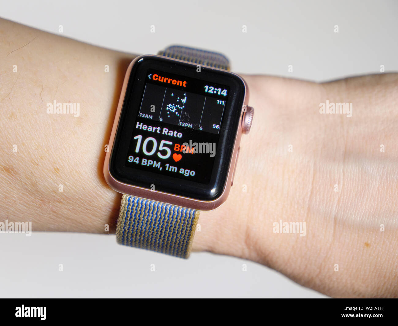 Apple Watch measuring heartbeat showing 105 beats per minute. Stock Photo