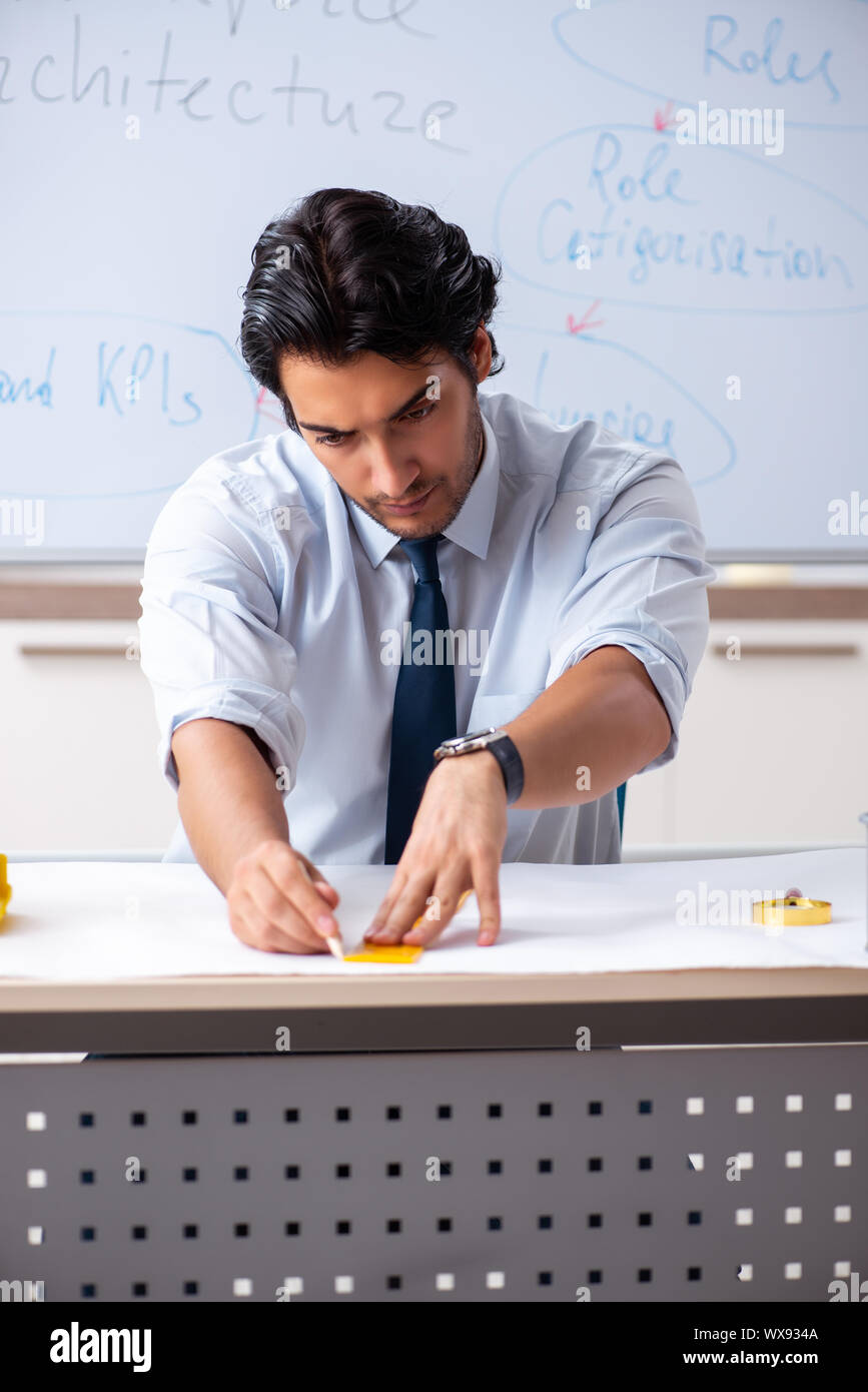 Young male architect in front of the whiteboard Stock Photo