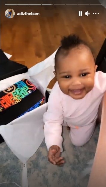 Lil Scrappy & Bambi Benson's daughter Xylo flashes a huge smile while playing with a Chanel box. | Source: Instagram.com/adizthebam