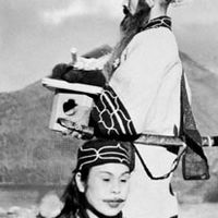 Ainu couple in ceremonial dress, Hokkaido, Japan.