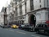 The Strand and the south facade of the Royal Courts of Justice, London. The griffin-topped Temple Bar, which marks the boundary between Westminster and the City of London, was erected in the 1670s to replace the 14th-century Temple Bar gatehouse.