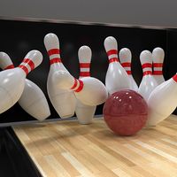 Bowling ball hitting all ten pins in a strike. (bowling alley, 10 pins, sports, recreation)