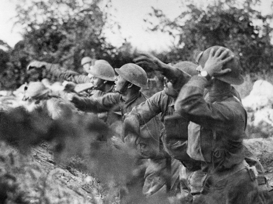 American troops at the front in Italy. American soldiers on the Piave (river) front hurling a shower of hand grenades into the Austrian trenches, Varage, Italy; September 16, 1918. (World War I)