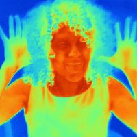 Thermal image portrait of mid adult woman with raised hands