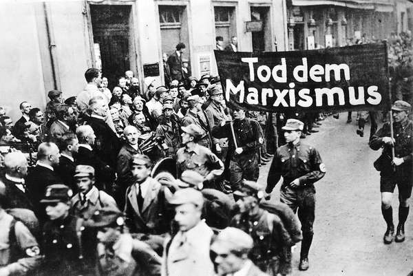 pg 229Nazi parade features a banner proclaiming, "Death to Marxism."The possibility of a peaceful Germany after World War I was precluded entirely by the terms of the Versailles Treaty and theintransigent hostility of France and England. Stripped of indu