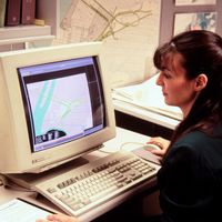 Computer mapping, woman at early 1990s computer