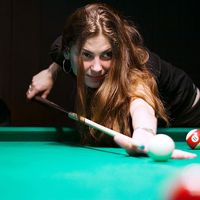 Billiards. Woman playing pool game.