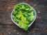 Coriander leaves, fresh green cilantro on wooden background, herbs