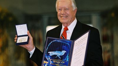 Jimmy Carter with the Nobel Peace Prize he was awarded in 2002.