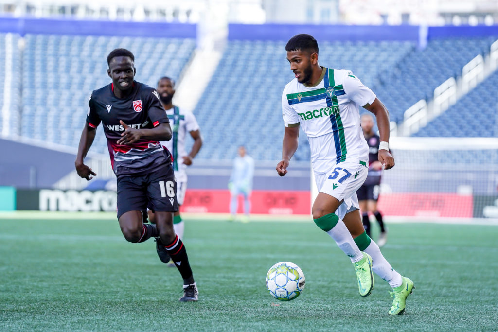 York United's Terique Mohammed plays the ball down field as Cavalry's Victor Loturi defends. (Photo: Canadian Premier League / Robert Reyes/William Ludwick)