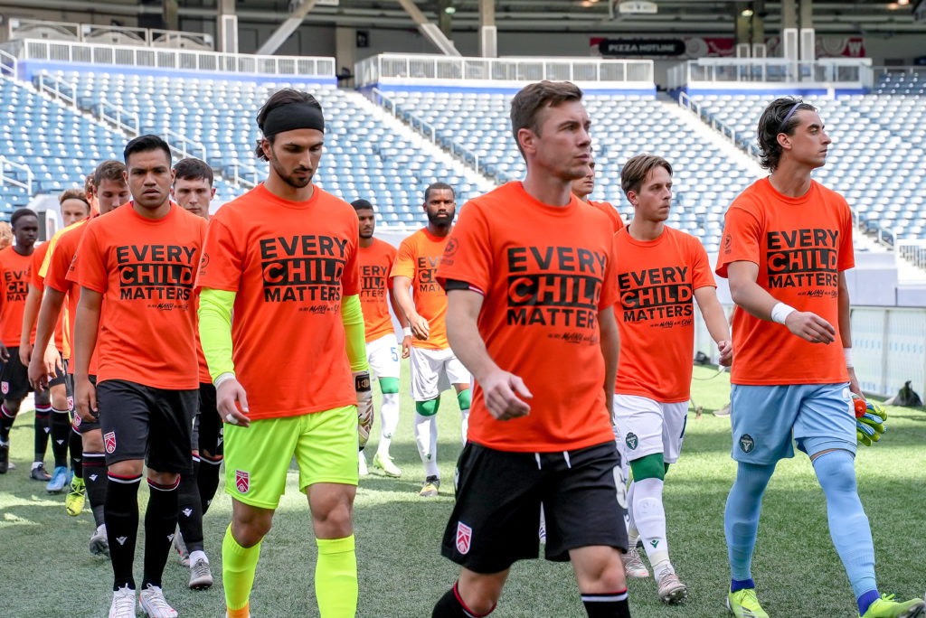 Cavalry FC and York United FC players head to the pitch for the start of the match. (Photo: Canadian Premier League / Robert Reyes/William Ludwick)