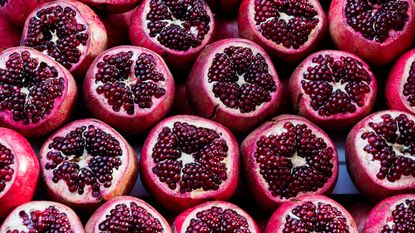 cut pomegranates showing seeds