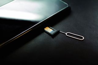 SIM card going into smartphone.