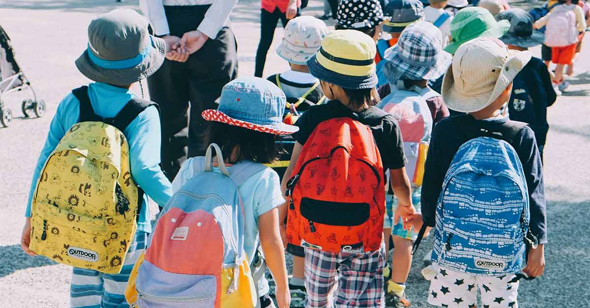 A group of young students walking outside