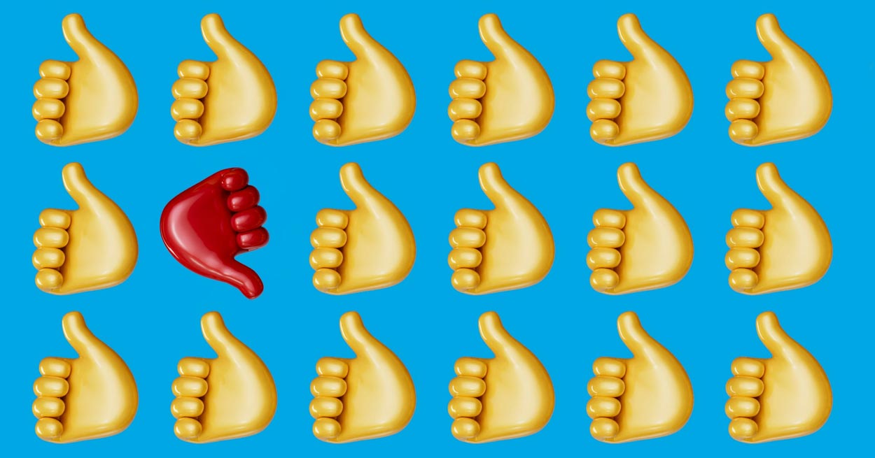 Eighteen yellow thumbs-up emojis are arranged in a grid against a blue background, with one red thumbs-down emoji standing out in the center of the image.