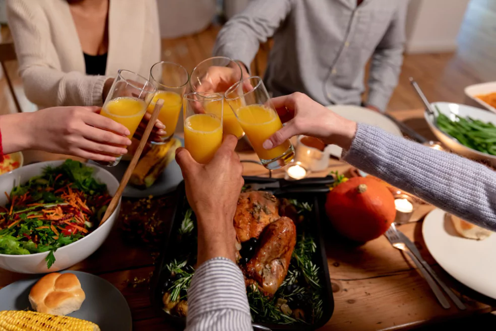 Friends and family celebrate Thanksgiving around a table laden with food