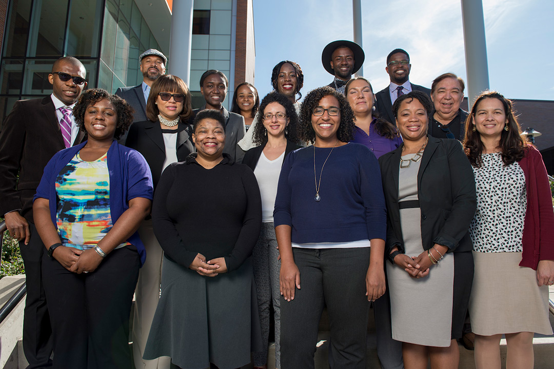 The Faculty Career Exploration Program participants pose for a photo, standing on the stairs in front of the sustainability building on the Henrietta campus.