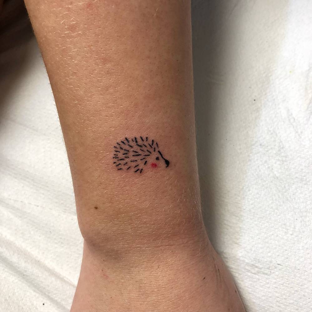 Hand poked hedgehog tattoo on the wrist.