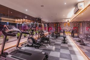 a gym with bikes and exercise equipment in a room at Ginger Bharuch in Bharuch