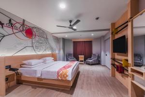 a bedroom with a bed and a flat screen tv at Ginger Bharuch in Bharuch