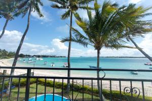 a view of the beach from the balcony of a resort at Garden Villas in Grand-Baie