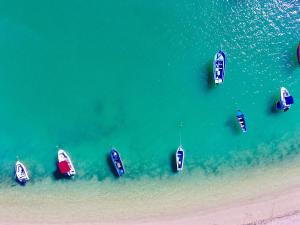 a group of boats in the water near a beach at Garden Villas in Grand-Baie