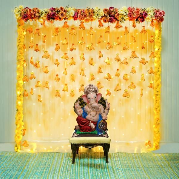 Immerse in divine elegance as your home resonates with the enchanting charm of our Flower and Tassel Ganpati Decorations.