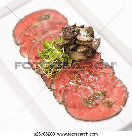 Stock Photography of Pepper charred beef carpaccio with mushrooms.