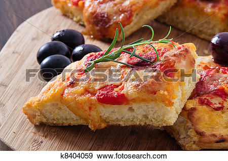 Stock Photograph of Focaccia with tomato and black olives.