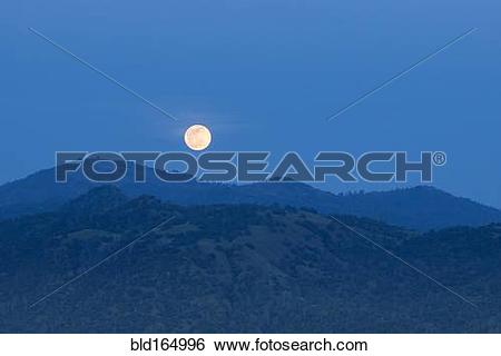 Stock Images of Glowing moon rising over foothills, Oakhurst.