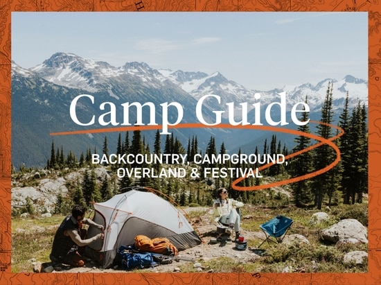 An orange border surrounds a beautiful camping scene. Two people sit next to a tent. In the background, massive mountains loom with a touch of snow on top. The words “Camp Guide” appear just over the tent with a subhead that reads “Backcountry, campground, overland & festival”. An orange swoosh underlines “Camp Guide”.