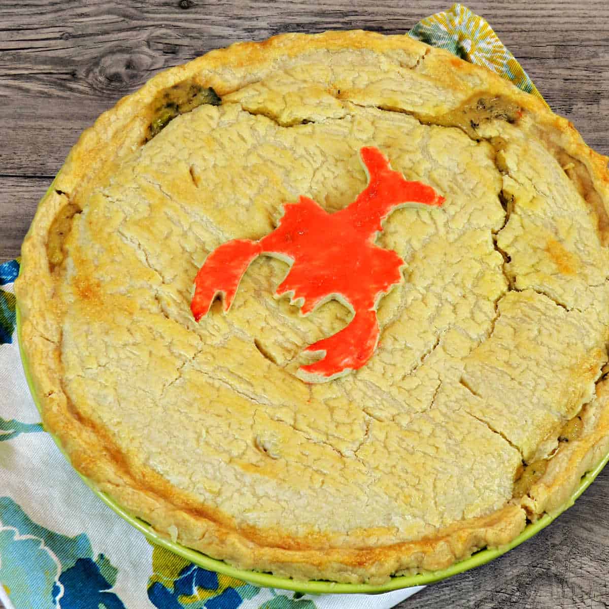 Looking down on a Lobster Pot Pie Pie with a cute red painted lobster cookie on top.